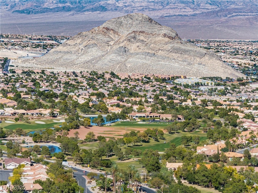 View of property location with mountains, nearby suburban area, and a local golf course