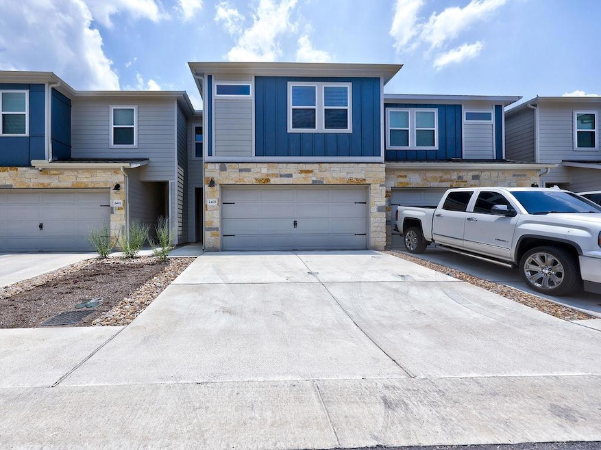 View of property featuring an attached garage, co