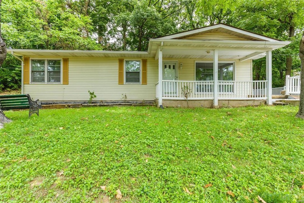 Vinyl siding and a covered front porch greet you a