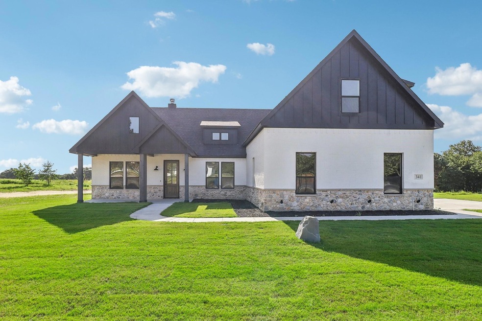 Modern farmhouse style home with a front lawn
