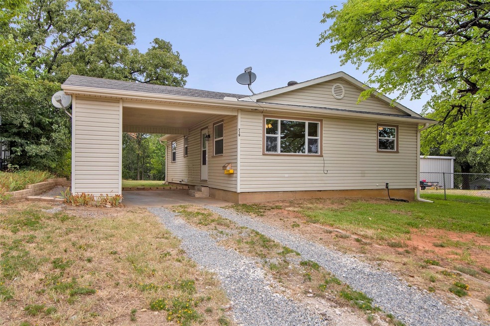 Front of the home with a carport