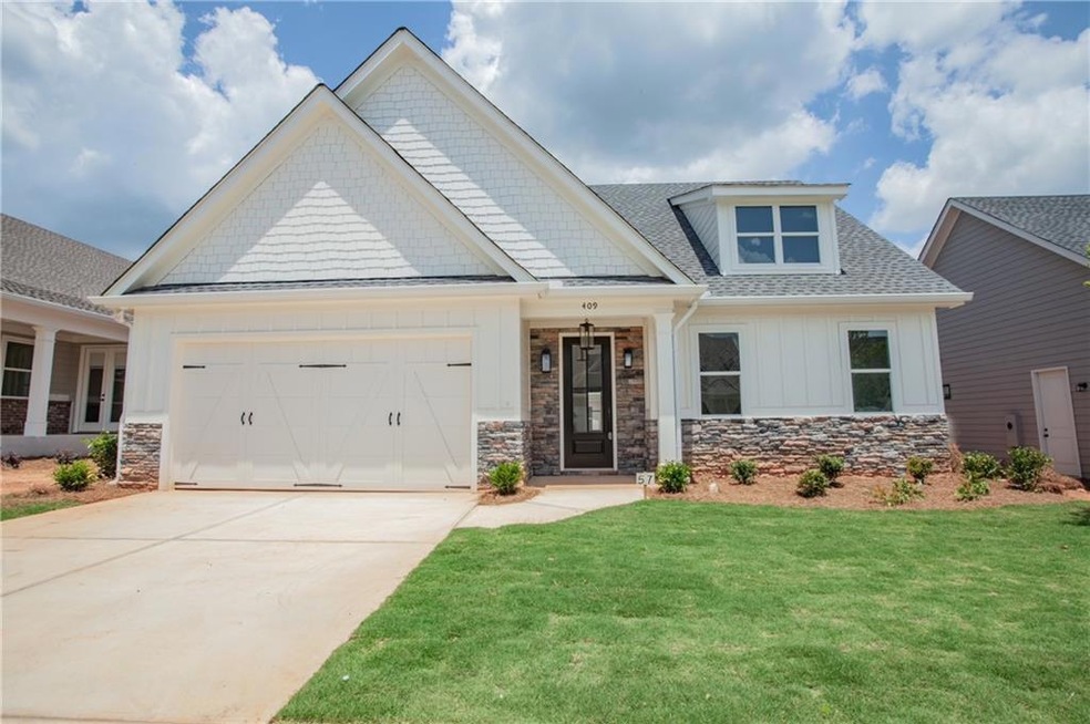 Craftsman inspired home featuring a garage and a f