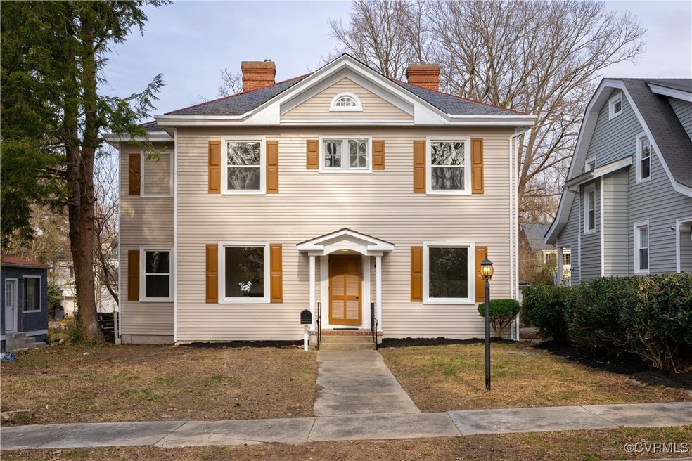 View of front of property featuring a chimney and