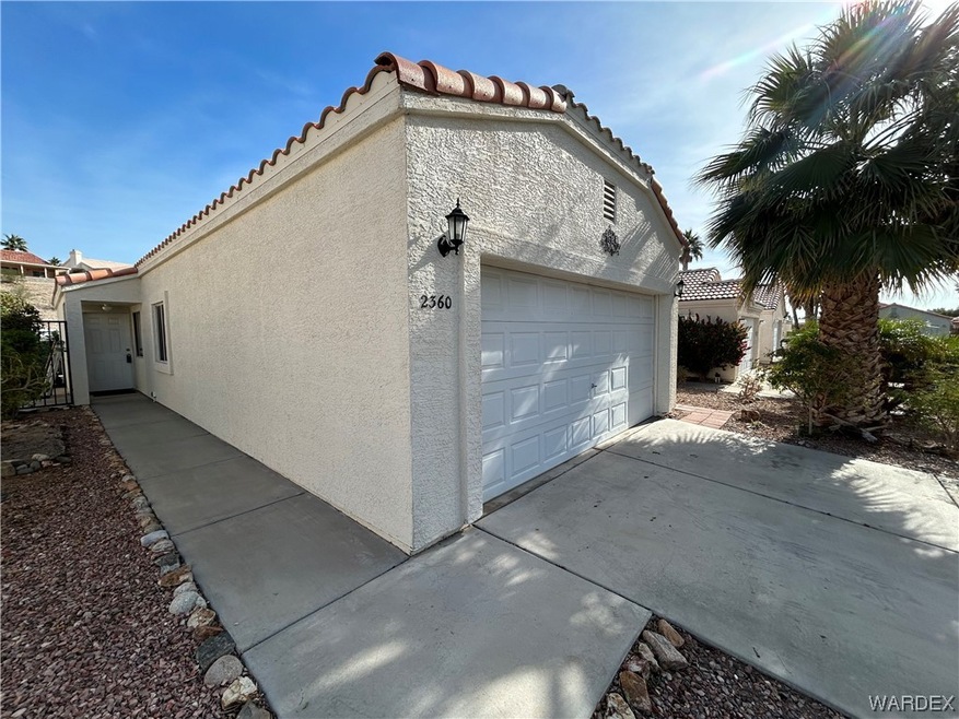 View of side of property with a garage