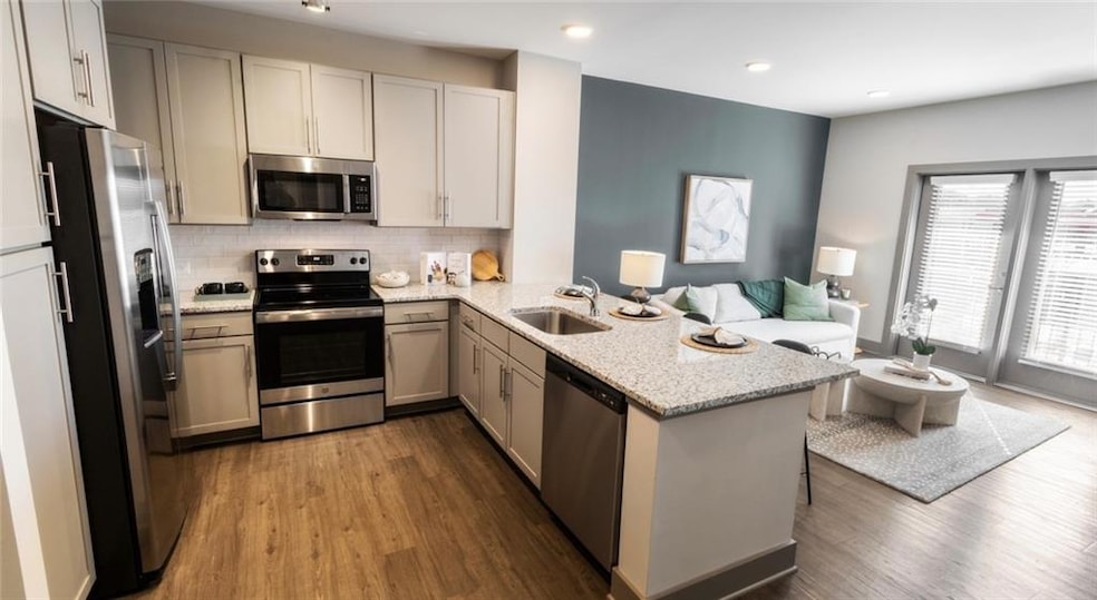 Kitchen with hardwood / wood-style flooring, stain