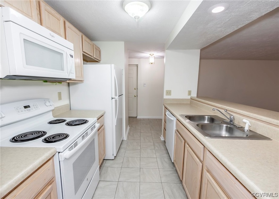 Kitchen featuring light countertops, newer white a