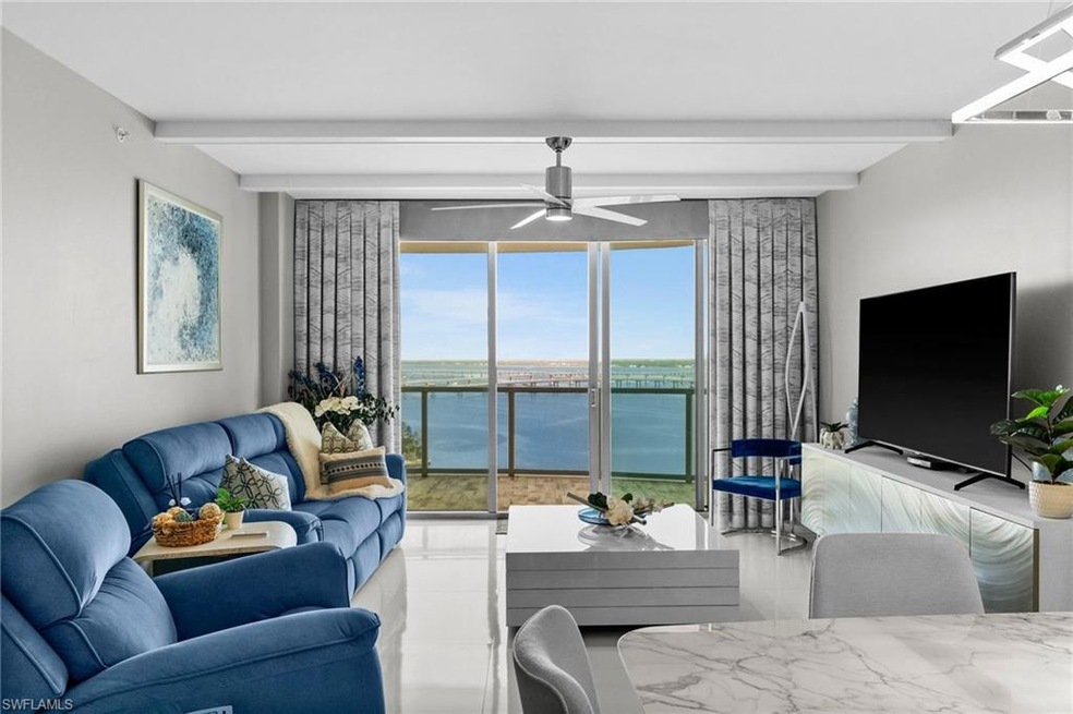 Living room featuring ceiling fan and beam ceiling