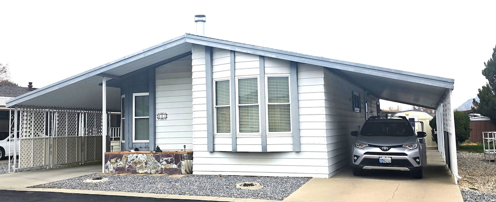 View of side of property featuring a carport and driveway