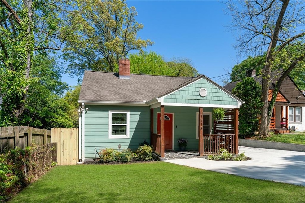 View of front of home with a chimney, covered porch, and roof with shingles