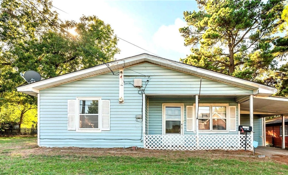 Bungalow-style home with a porch, an attached carp