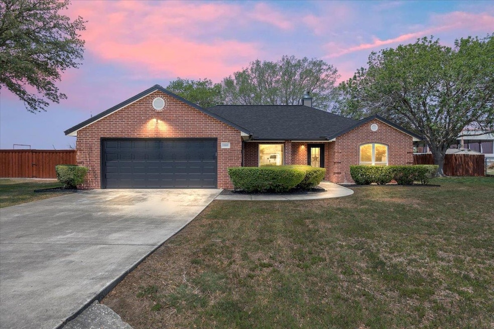 Ranch-style house with an attached garage, brick 