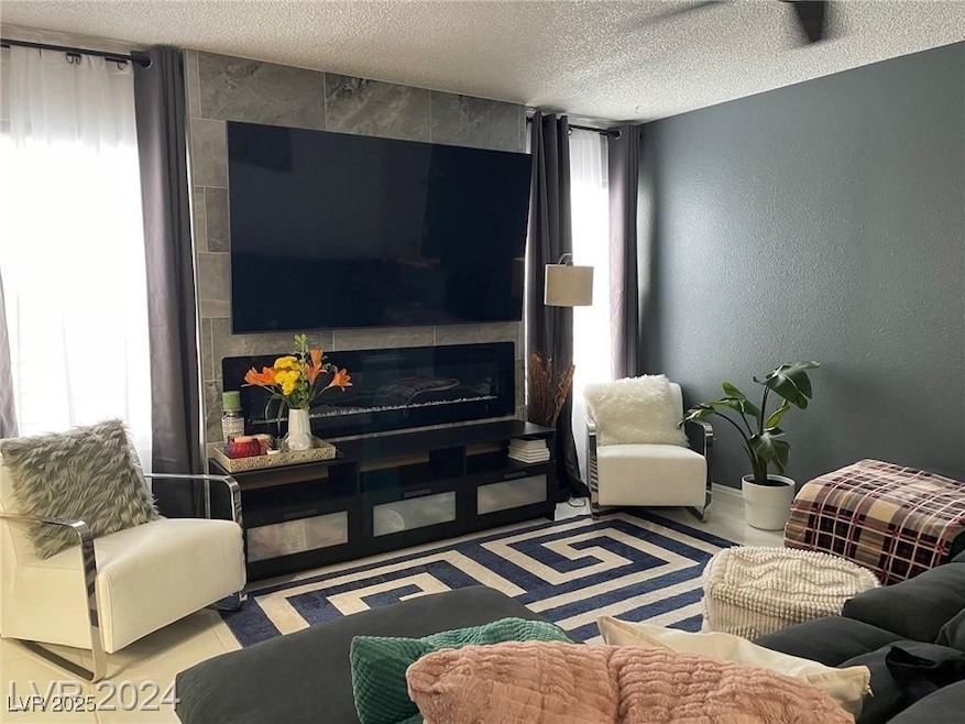 Living area featuring a textured ceiling and a tex