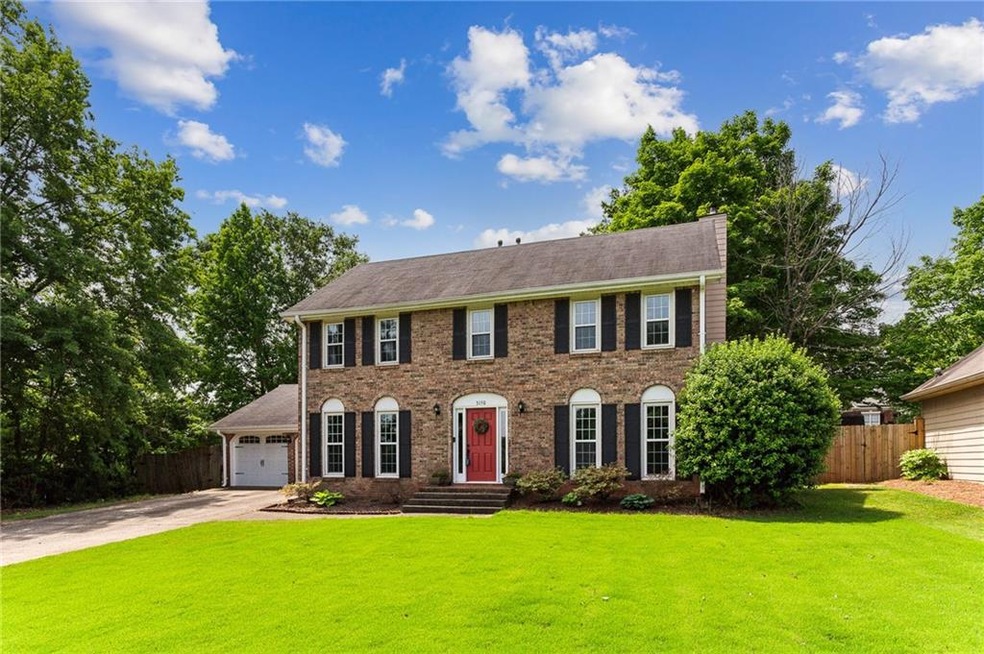 Colonial house featuring a front yard