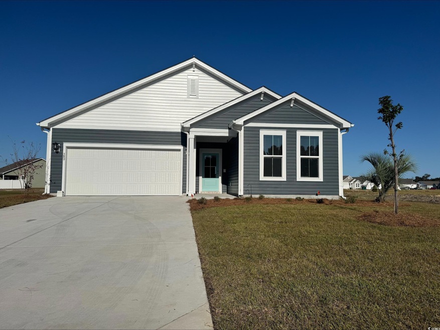 View of front facade with a garage and a front lawn