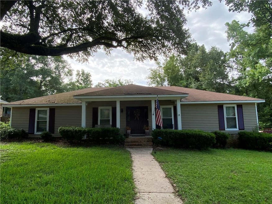 Single story home featuring a front lawn and covered porch