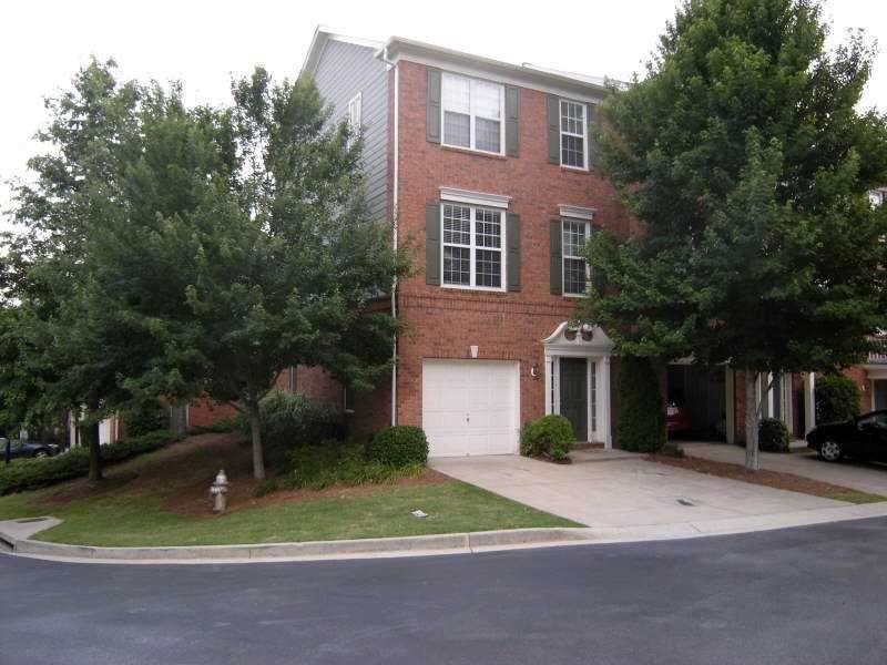 Exterior Front. End unit, multi-level townhome wit