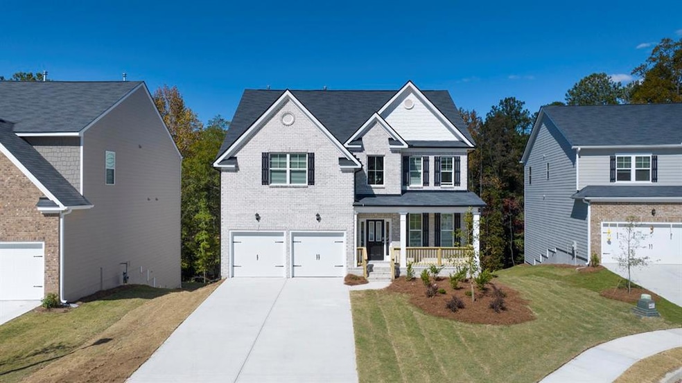 Traditional-style home with a porch, an attached g