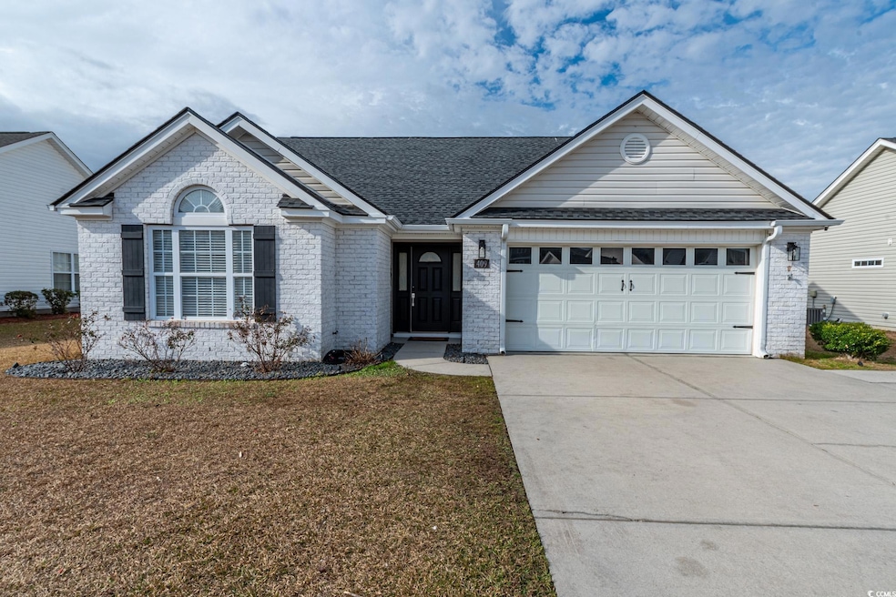 Ranch-style house with a front yard and a garage
