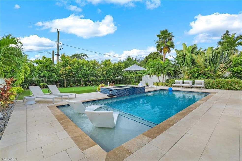 View of pool with an in ground hot tub and a patio