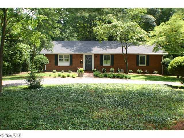Exterior Front. Nestled in mature landscaping, this home welcomes you.