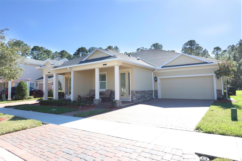 Front Exterior Decorative Stone & Sealer Paved Driveway