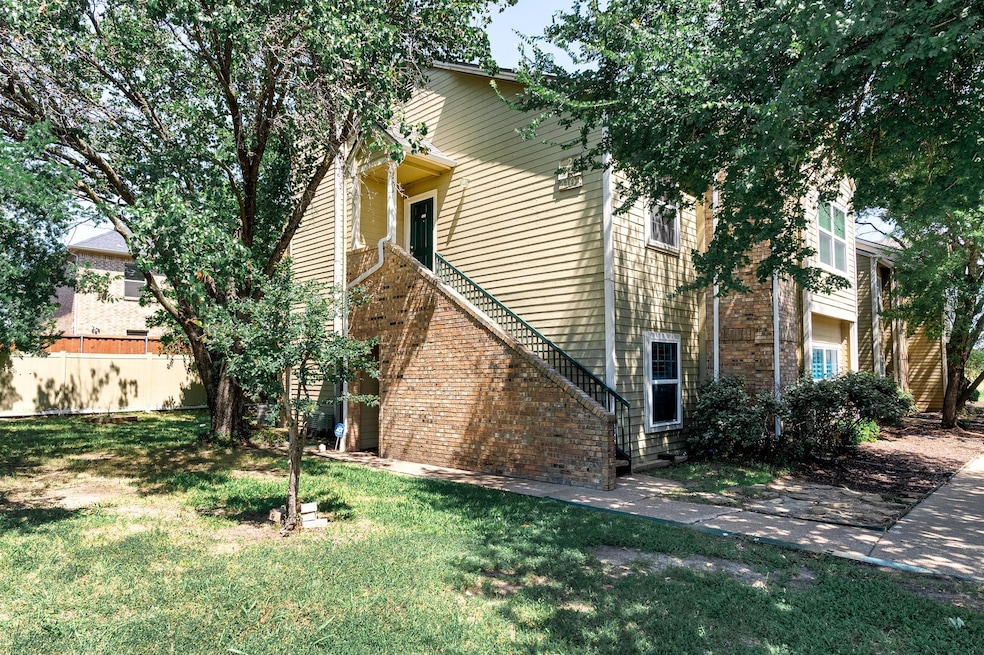 View of side of property with a lawn