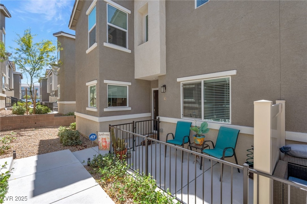 Property entrance with stucco siding, a patio area