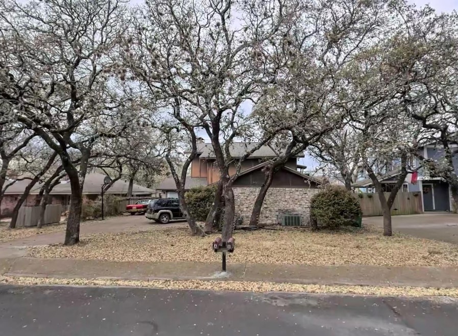 Obstructed view of property featuring stone sidin