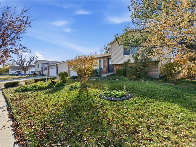 View of front of house with brick siding and a front yard