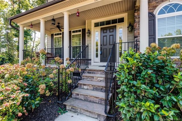 Welcoming wide front porch with ceiling fan and ro