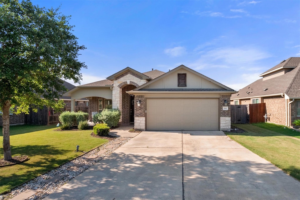 View of front facade with driveway, brick siding,