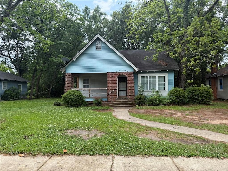 Bungalow-style house featuring a porch, a front la