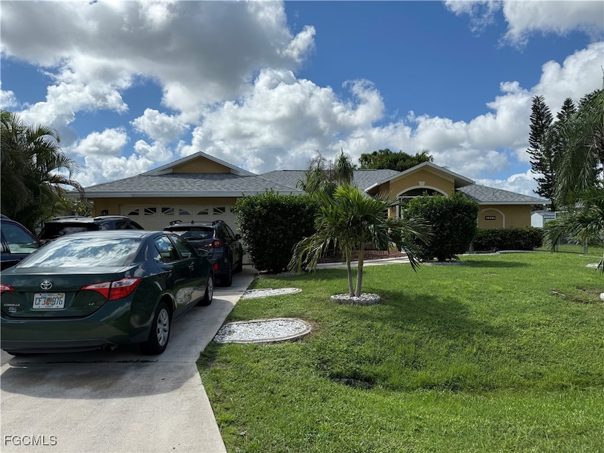View of front of home featuring concrete driveway, a front lawn, an attached garage, and roof with shingles