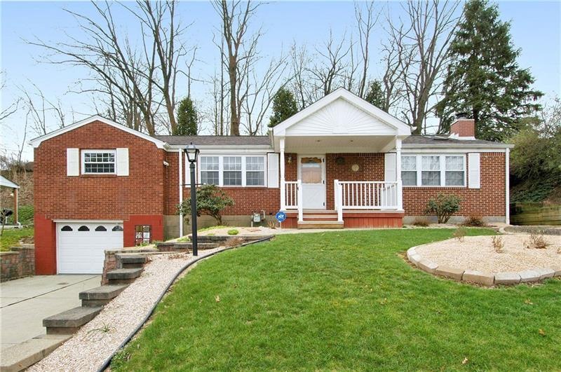This stunning ranch has a beautiful yard and many 