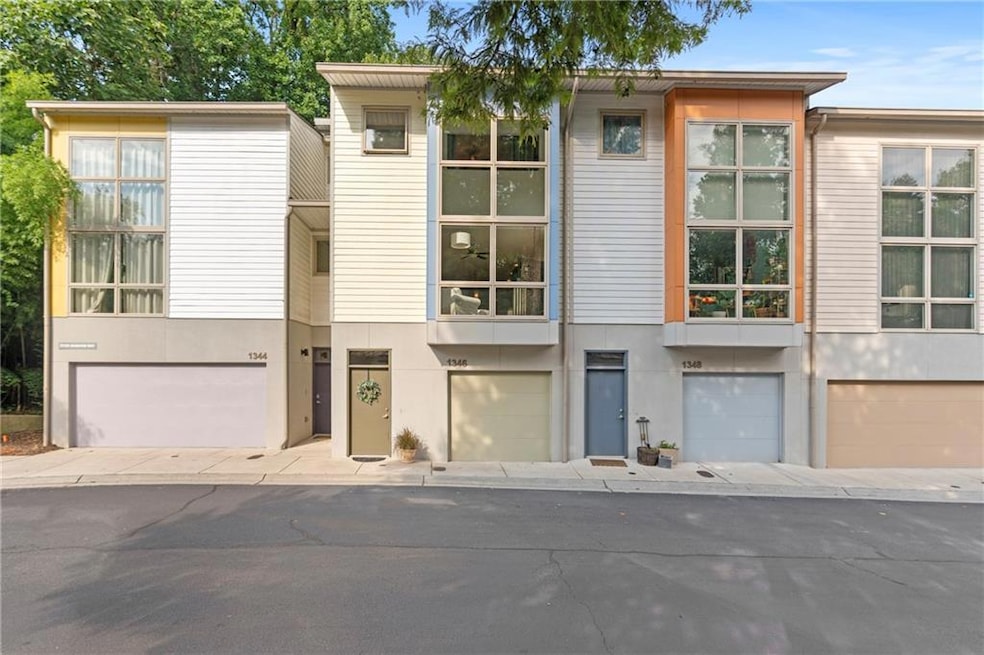 View of property featuring stucco siding and an attached garage