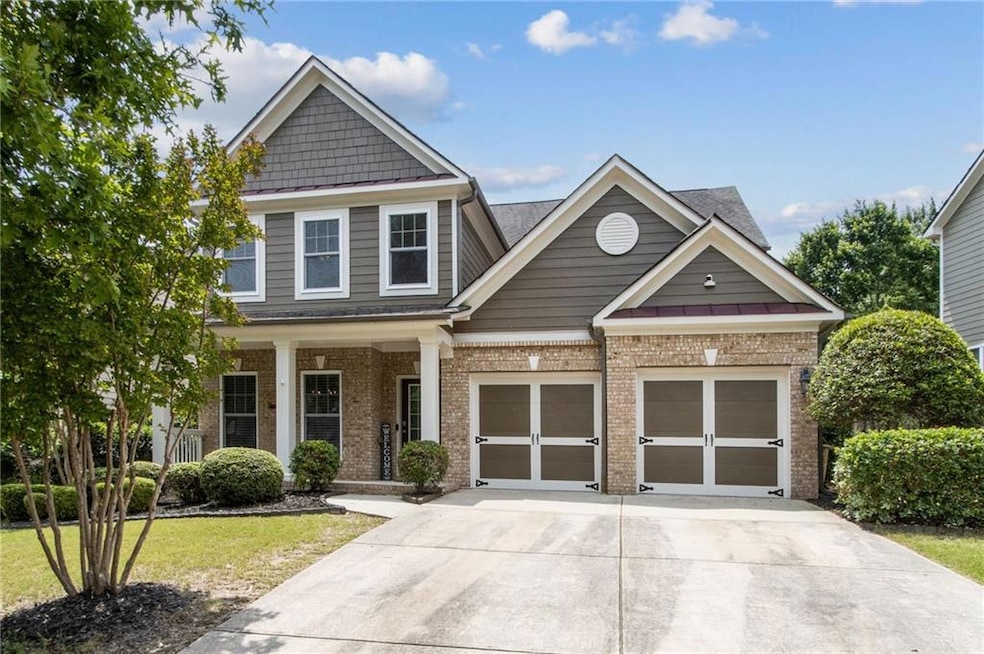 Craftsman-style home with brick siding, driveway, a garage, a porch, and roof with shingles