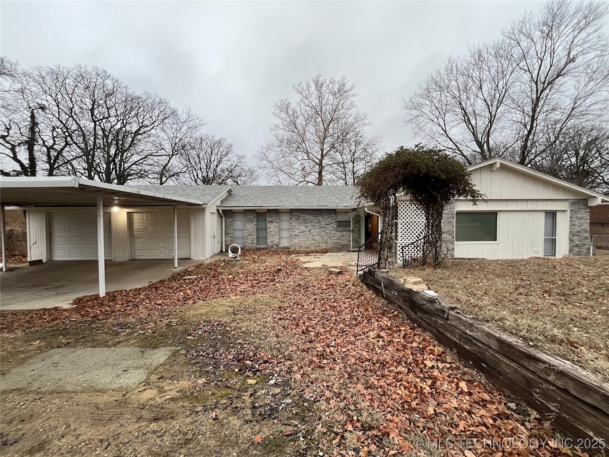 View of front of home featuring a carport, a garag