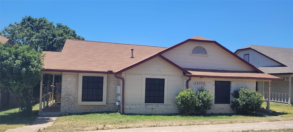 View of front of house with stone siding, a shing