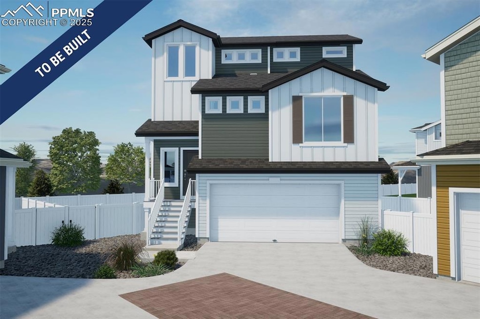 View of front of home featuring board and batten siding, driveway, and a garage