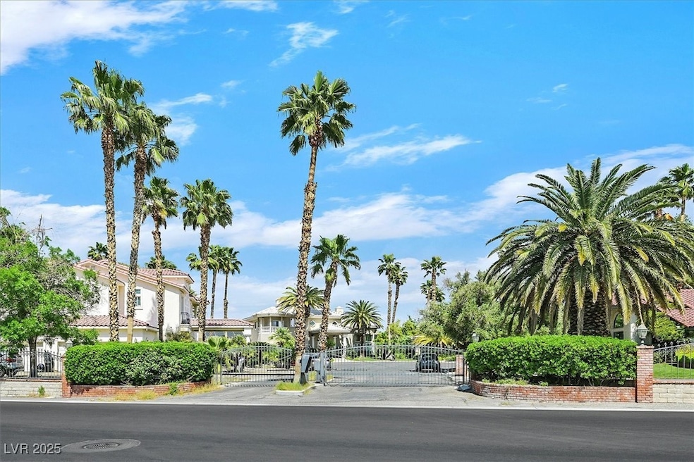 View of asphalt road featuring a gate, a gated entry, and a residential view