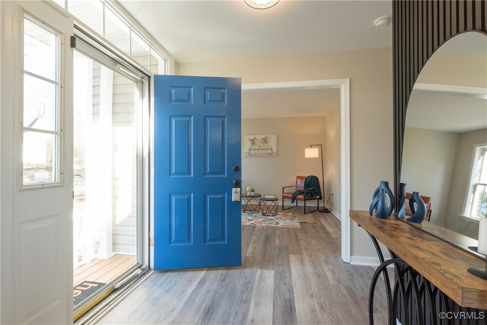 Foyer entrance featuring light hardwood / wood-sty