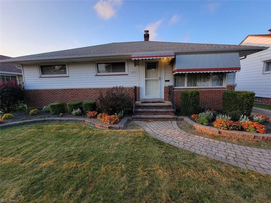Single story home featuring a front lawn