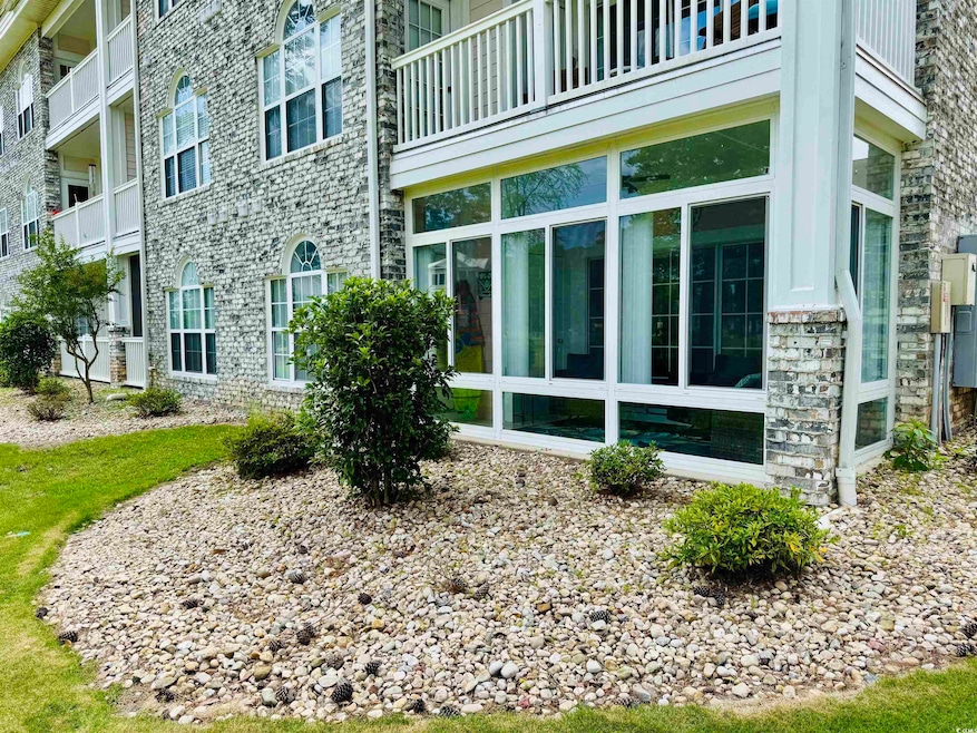 View of property exterior with stone siding and a balcony