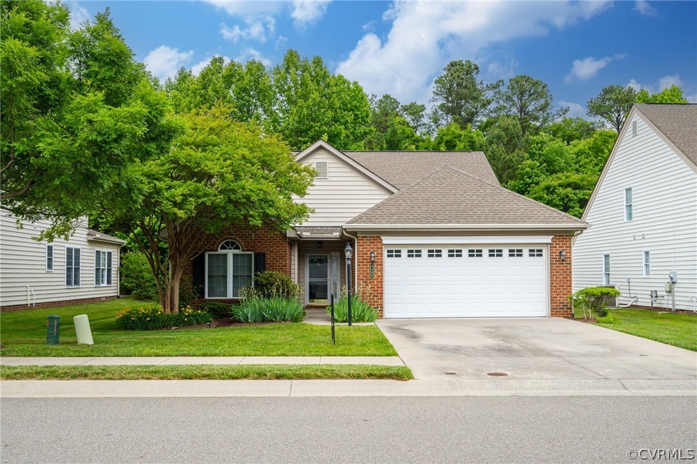 View of front of home with a garage and a front la