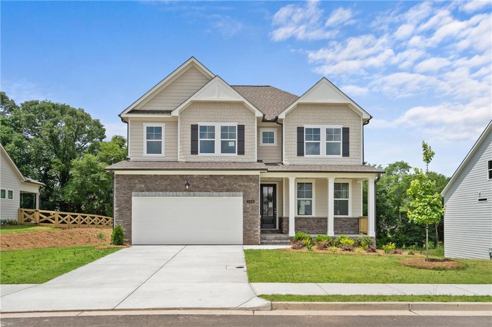 Craftsman-style house with a porch, concrete driveway, an attached garage, stone siding, and roof with shingles