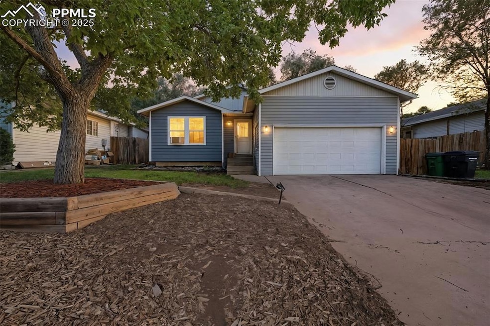 Ranch-style house featuring a garage and concrete driveway