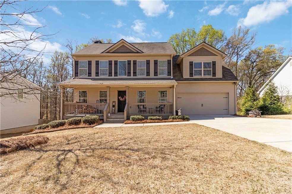 Colonial home featuring driveway, covered porch, a