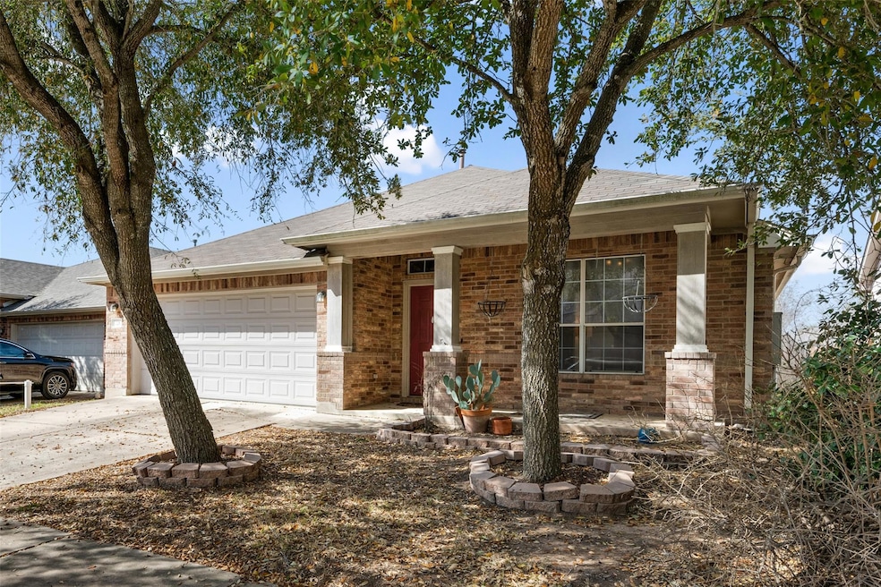 Single story home featuring driveway, brick sidin