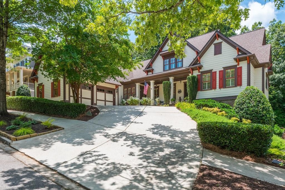 View of front of home with concrete driveway, covered porch, and a shingled roof
