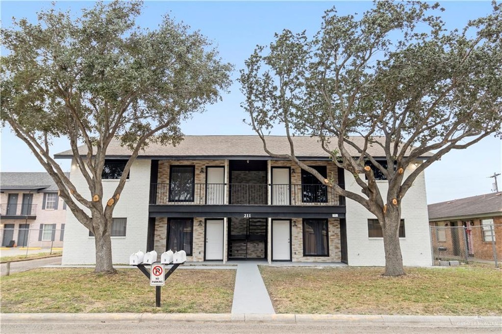 Townhome / multi-family property featuring a balcony and a front lawn